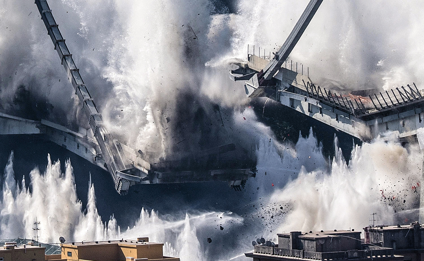 A general view shows the demolition of the large towers '10' and '11' of the Morandi bridge using micro-explosive charges, in Genoa, northern Italy, 28 June 2019. Thousands of people were evacuated ahead of the demolition works, which started on the day. Experts have blown up the remains of the bridge which partially collapsed on 14 August 2018 killing 43 people. A new viaduct replacing the Morandi bridge is expected to be completed by 2020. ANSA/LUCA ZENNARO